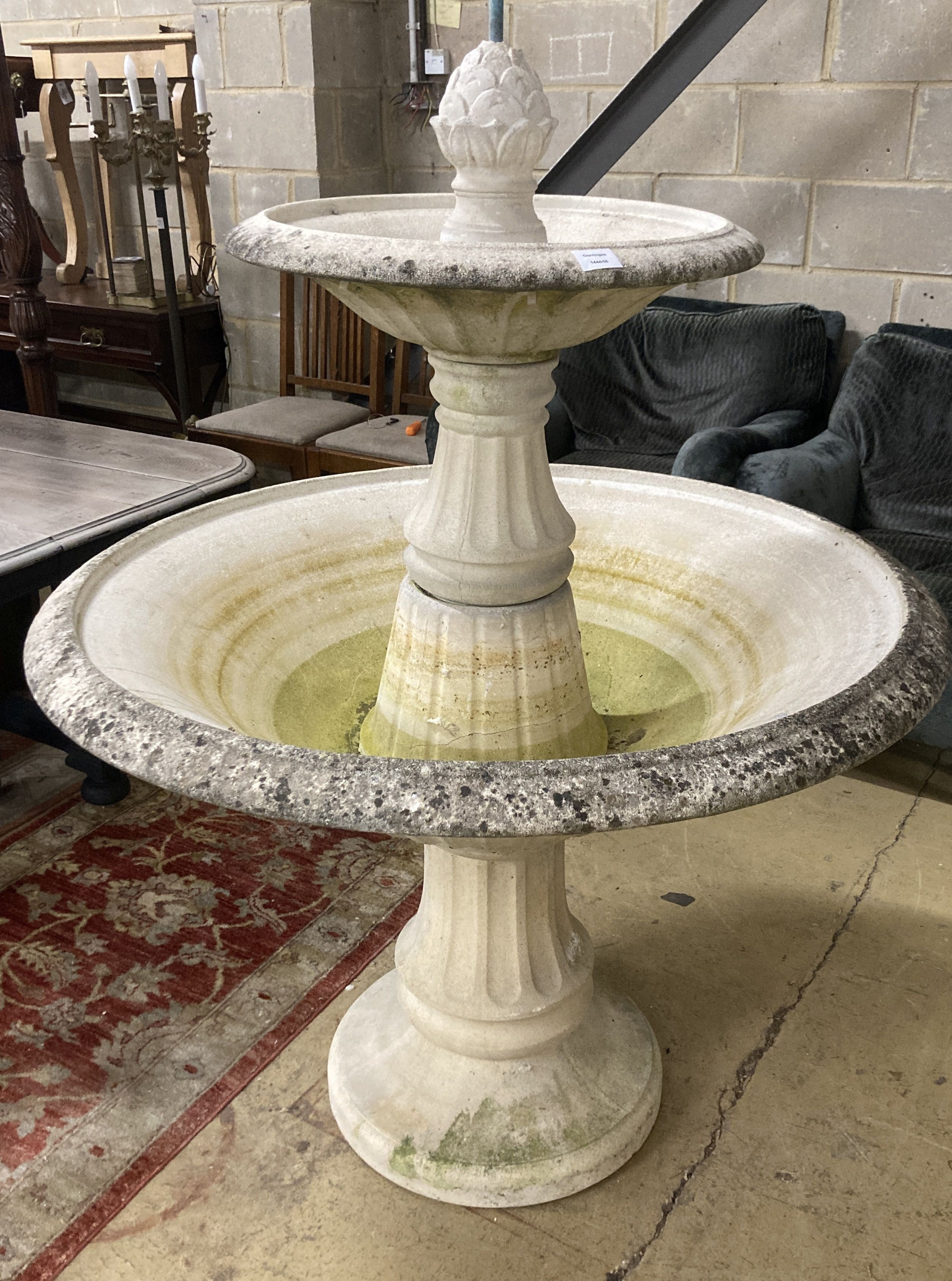 A reconstituted stone circular two tier garden fountain, (faults), diameter 110cm H.140cm